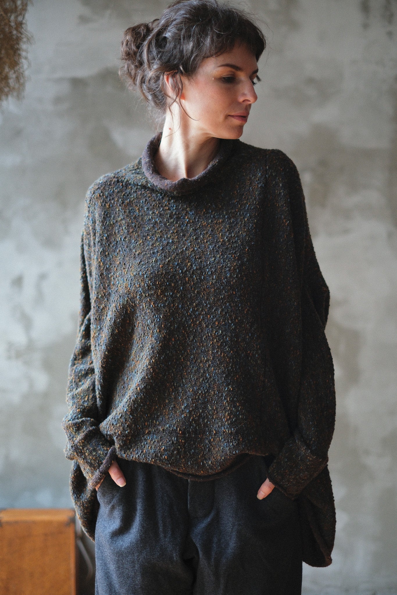 Model wears brown flecked jumper inside out, made from superfine merino wool, designed and made in Melbourne by Wendy Voon knits.