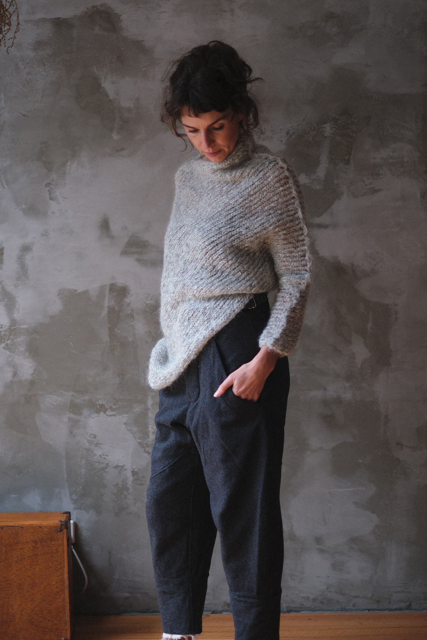 Model wears a mohair cocoon sleeved jumper in a natural colour.