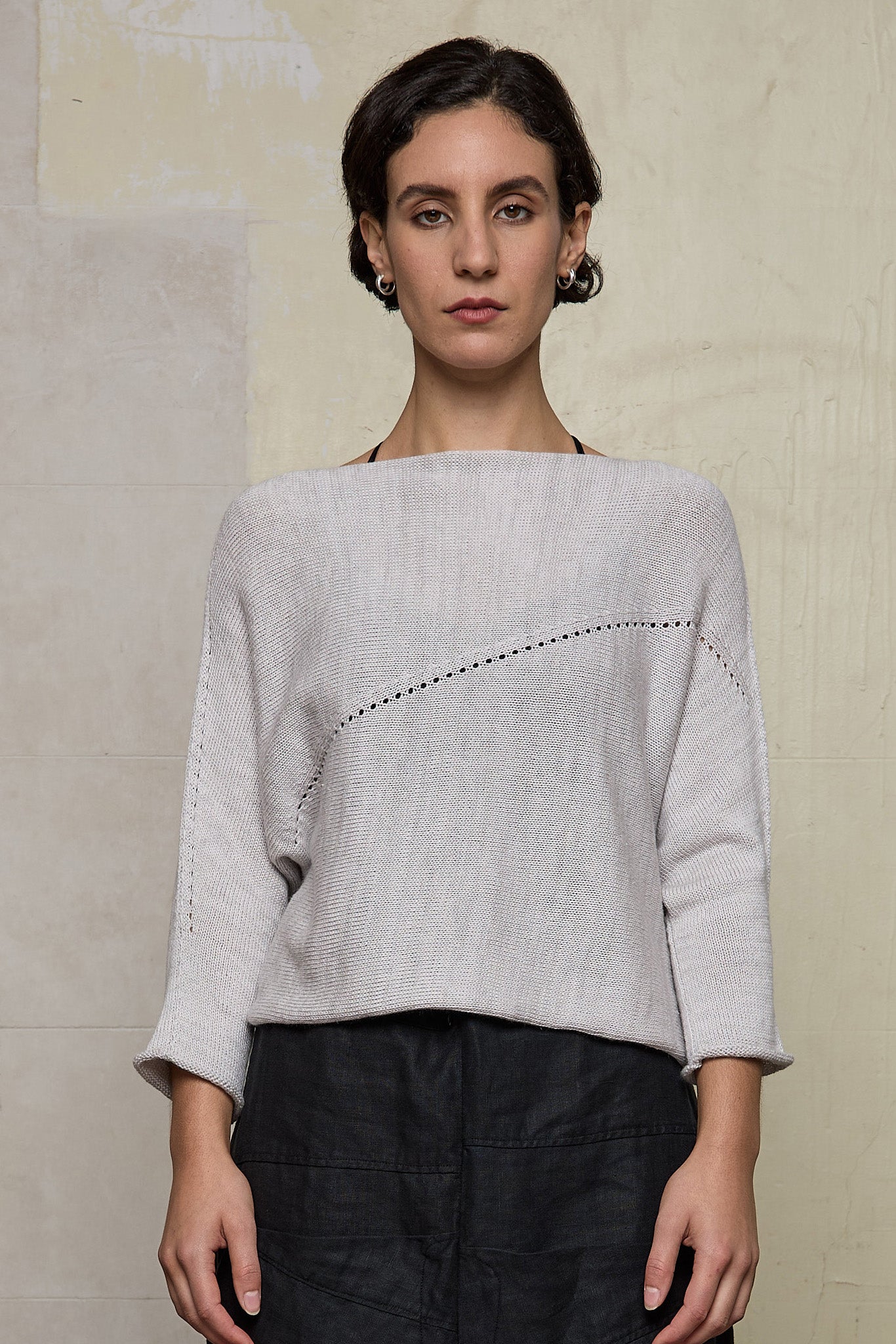Front view of model wearing a natural coloured knitted batwing, designed and knitted in Melbourne by Wendy Voon knits