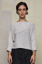 Front view of model wearing a natural coloured knitted batwing, designed and knitted in Melbourne by Wendy Voon knits
