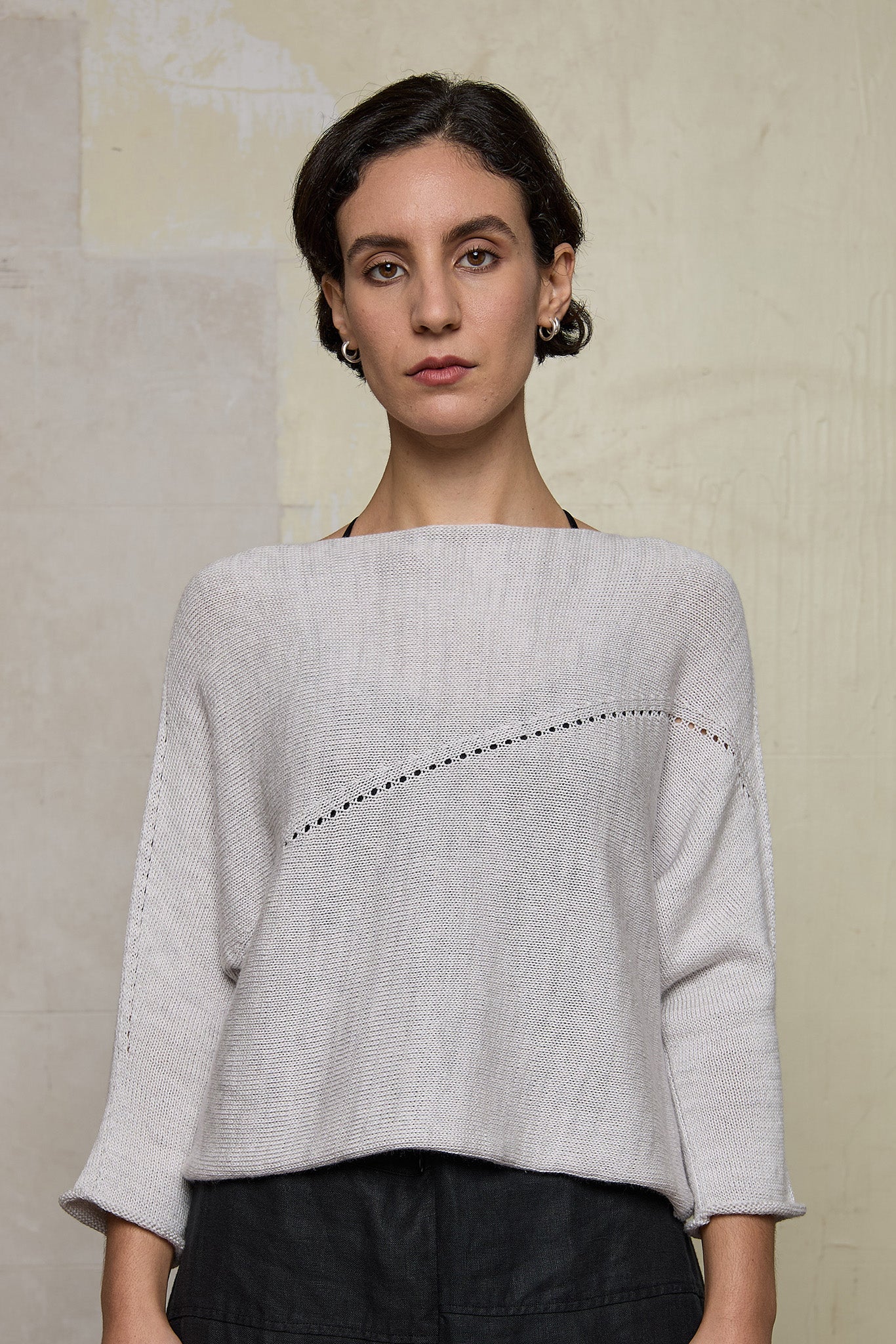 Front view of model wearing a natural coloured knitted batwing, designed and knitted in Melbourne by Wendy Voon knits