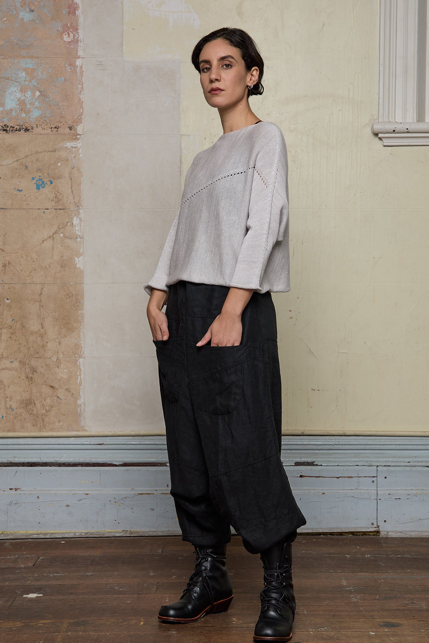 Front view of model wearing a knitted natural coloured batwing, designed and knitted in Melbourne by Wendy Voon knits