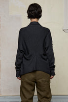 Back view of model wearing a knitted shawl collared cardigan in a charcoal colourway. Cardigan is designed and knitted in Melbourne by Wendy Voon knits.
