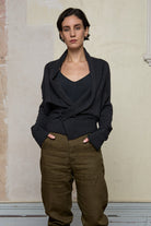 Model wears a knitted shawl collared cardigan pinned at the waist in a charcoal colourway.  Cardigan is designed and knitted in  Melbourne by Wendy Voon knits.