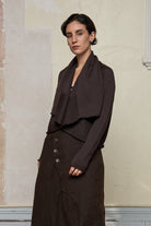 Model wears a knitted shawl collared cardigan upside down in a chocolate brown colourway.  Cardigan is designed and knitted in  Melbourne by Wendy Voon knits.