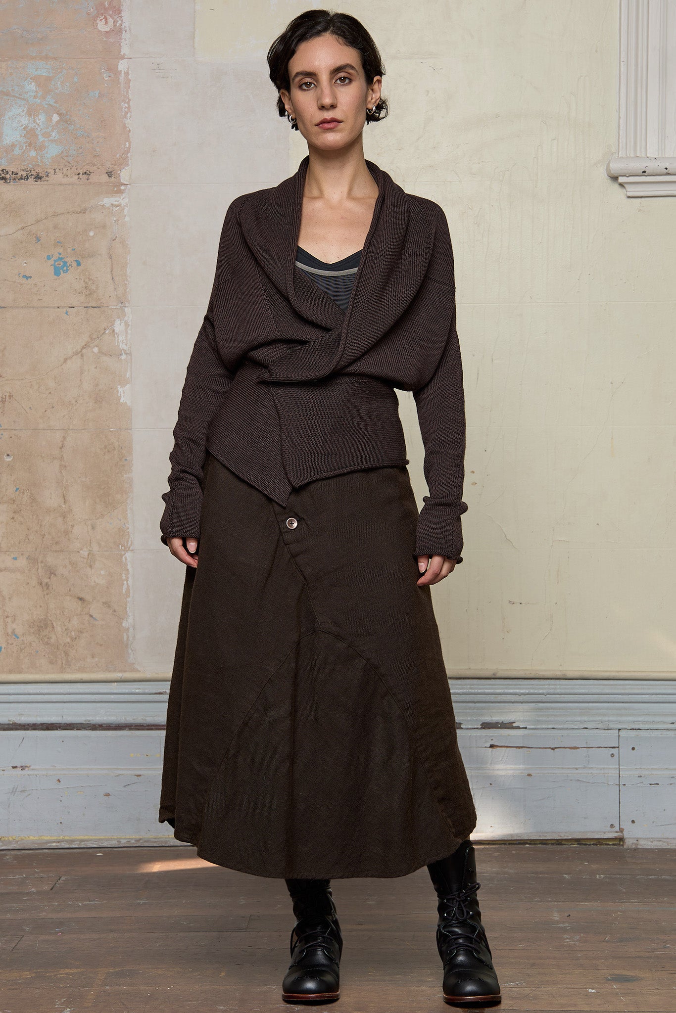 Model wears a knitted shawl collared cardigan pinned at the waist in a chocolate brown colourway.  Cardigan is designed and knitted in  Melbourne by Wendy Voon knits.
