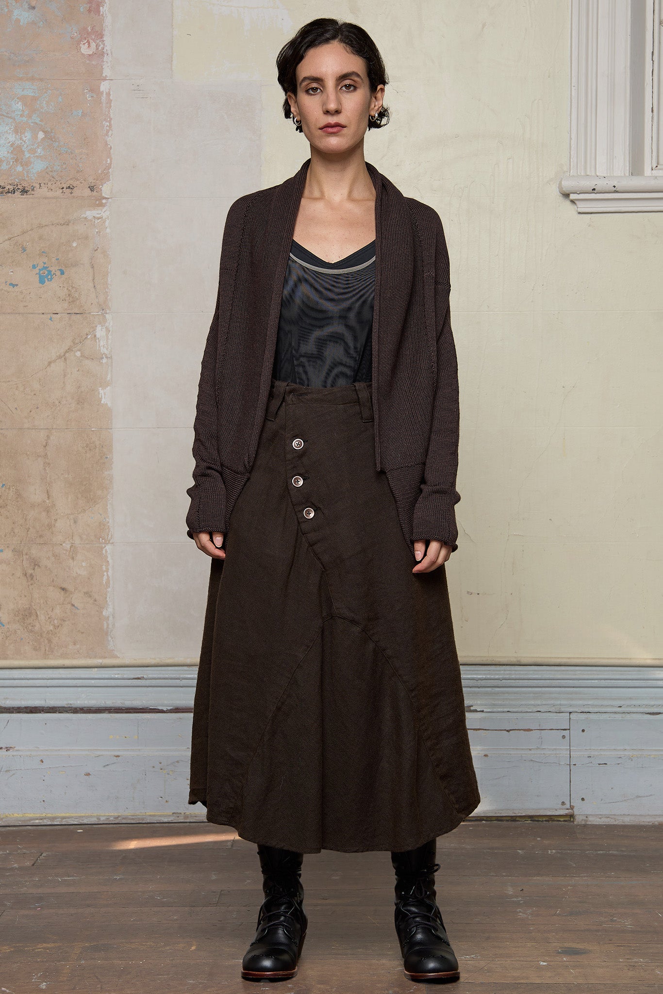 Model wears a knitted shawl collared cardigan unfastenned in a chocolate brown colourway.  Cardigan is designed and knitted in  Melbourne by Wendy Voon knits.