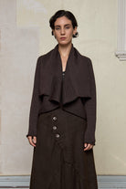Model wears a knitted shawl collared cardigan upside down in a chocolate brown colourway.  Cardigan is designed and knitted in  Melbourne by Wendy Voon knits.
