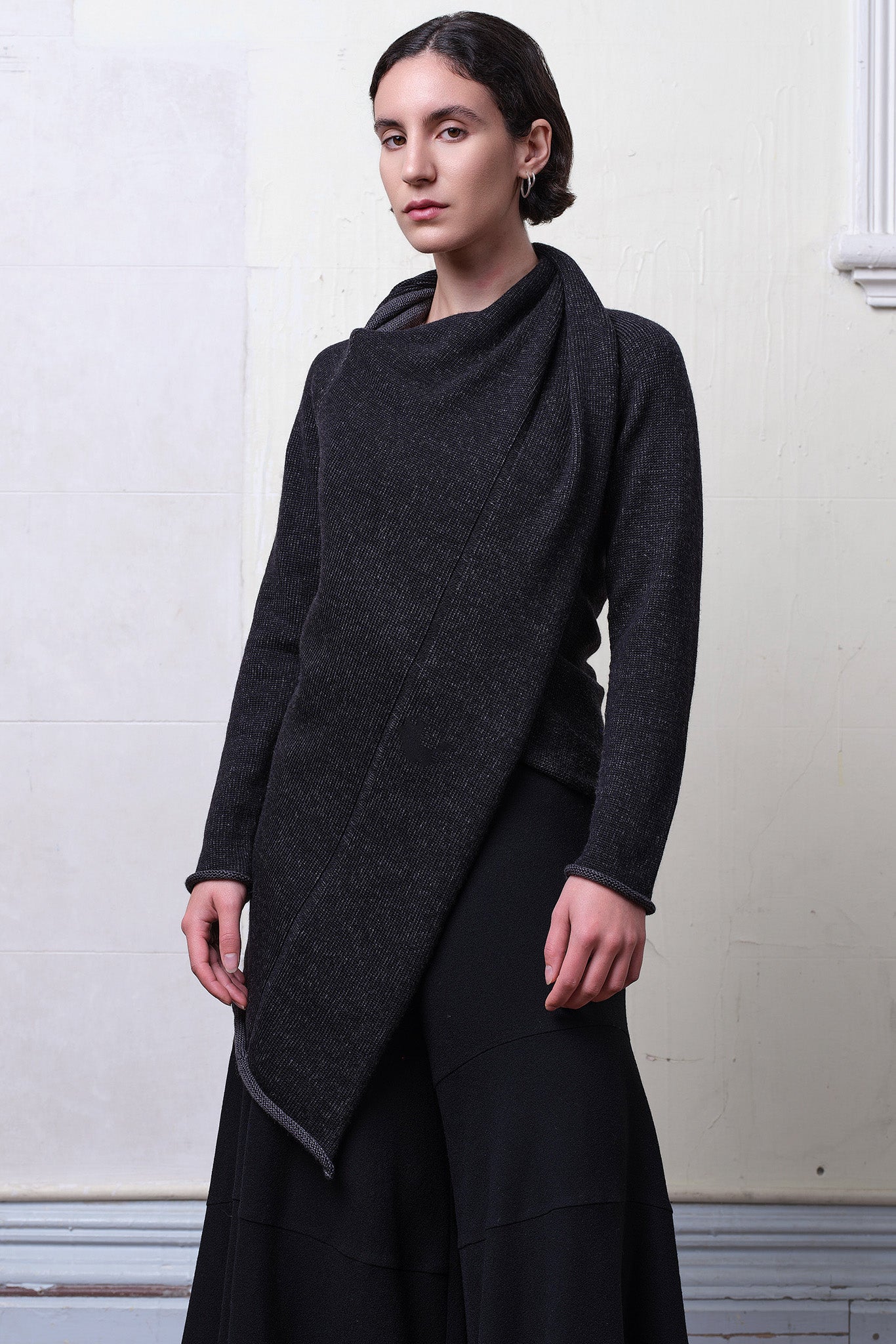 Model wears knitted merino cross over,  in black and charcoal colourway.