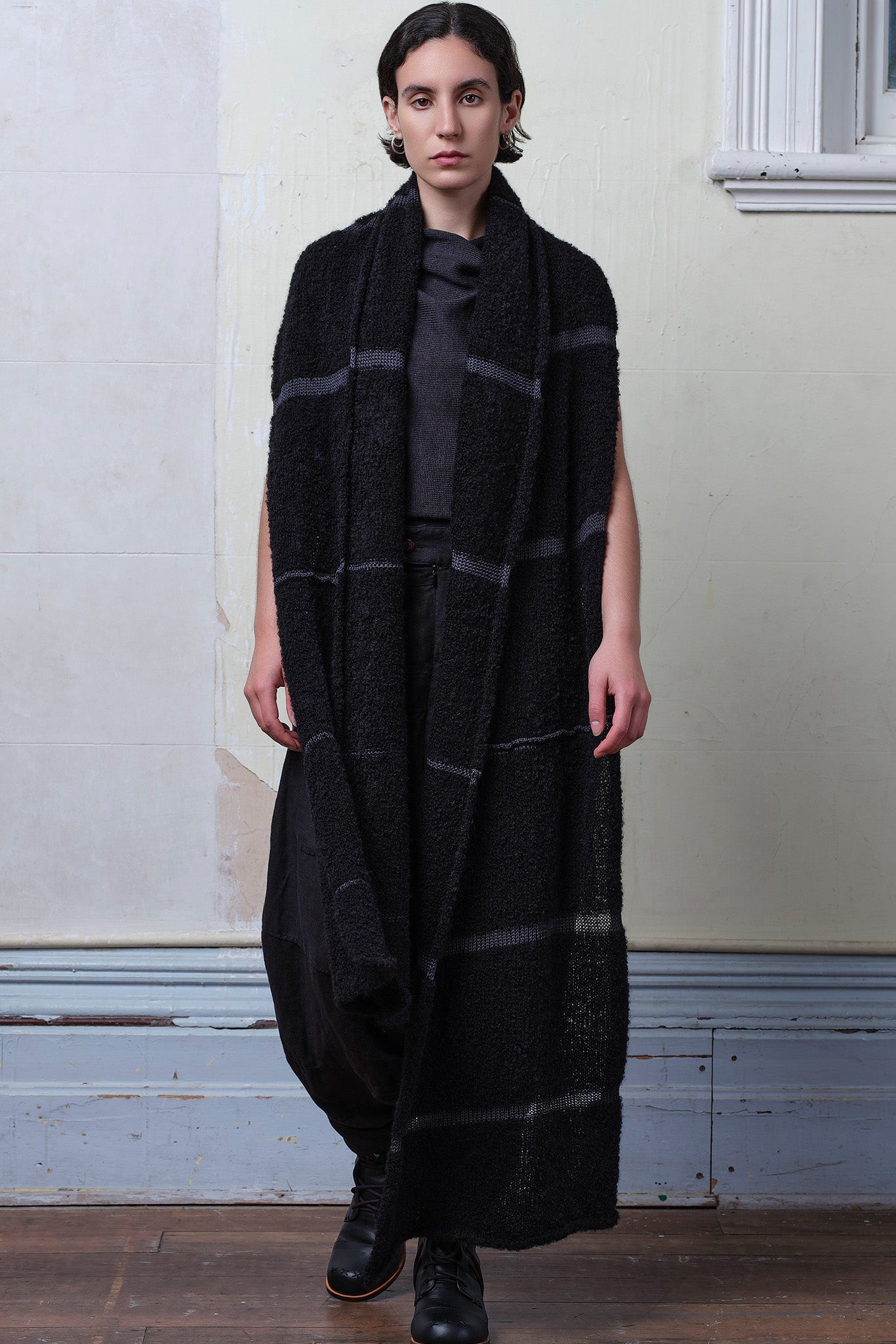 Model wears knitted black alpaca wrap with contrasting slate cotton stripes
