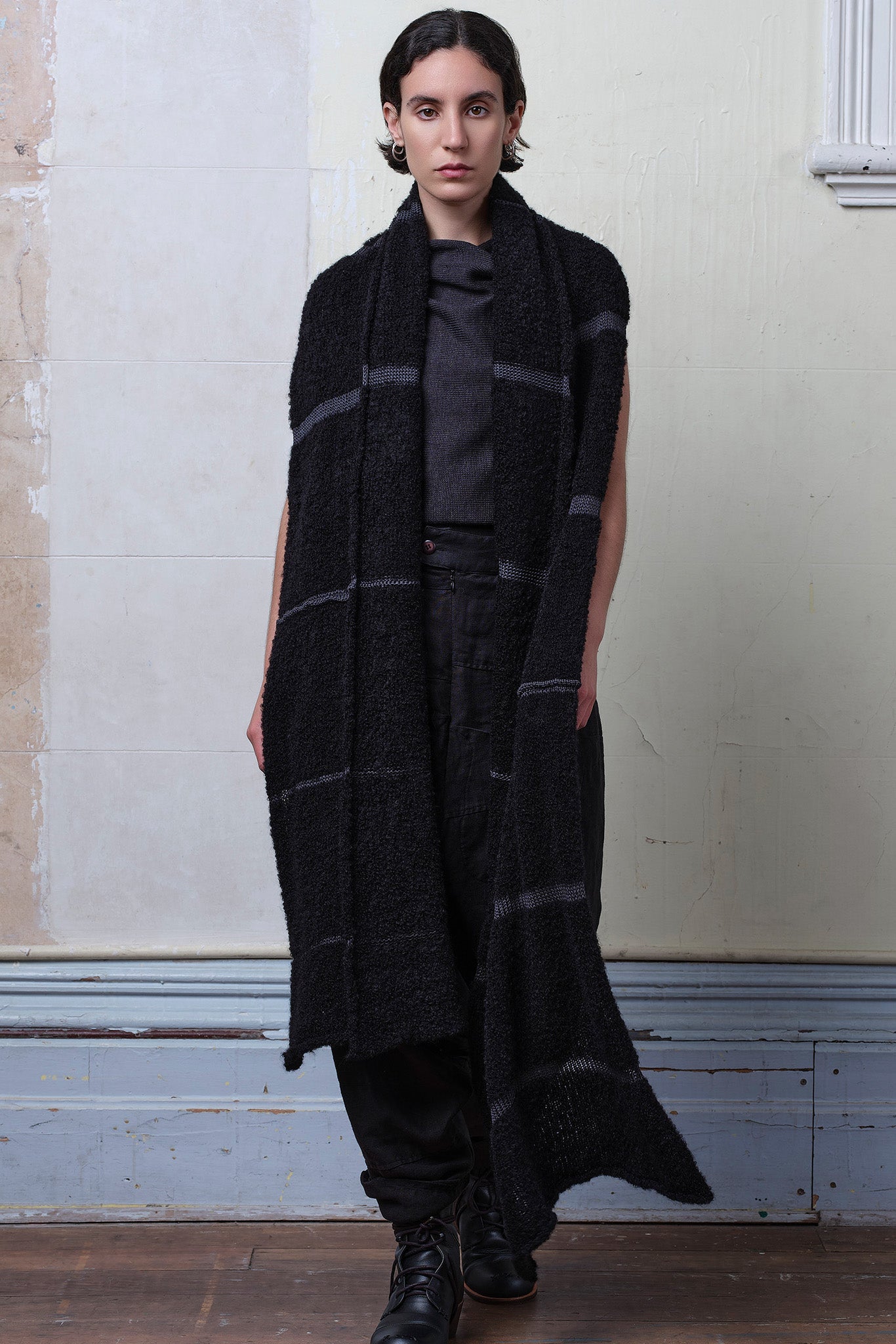 Model wears knitted black alpaca wrap with contrasting slate cotton stripes