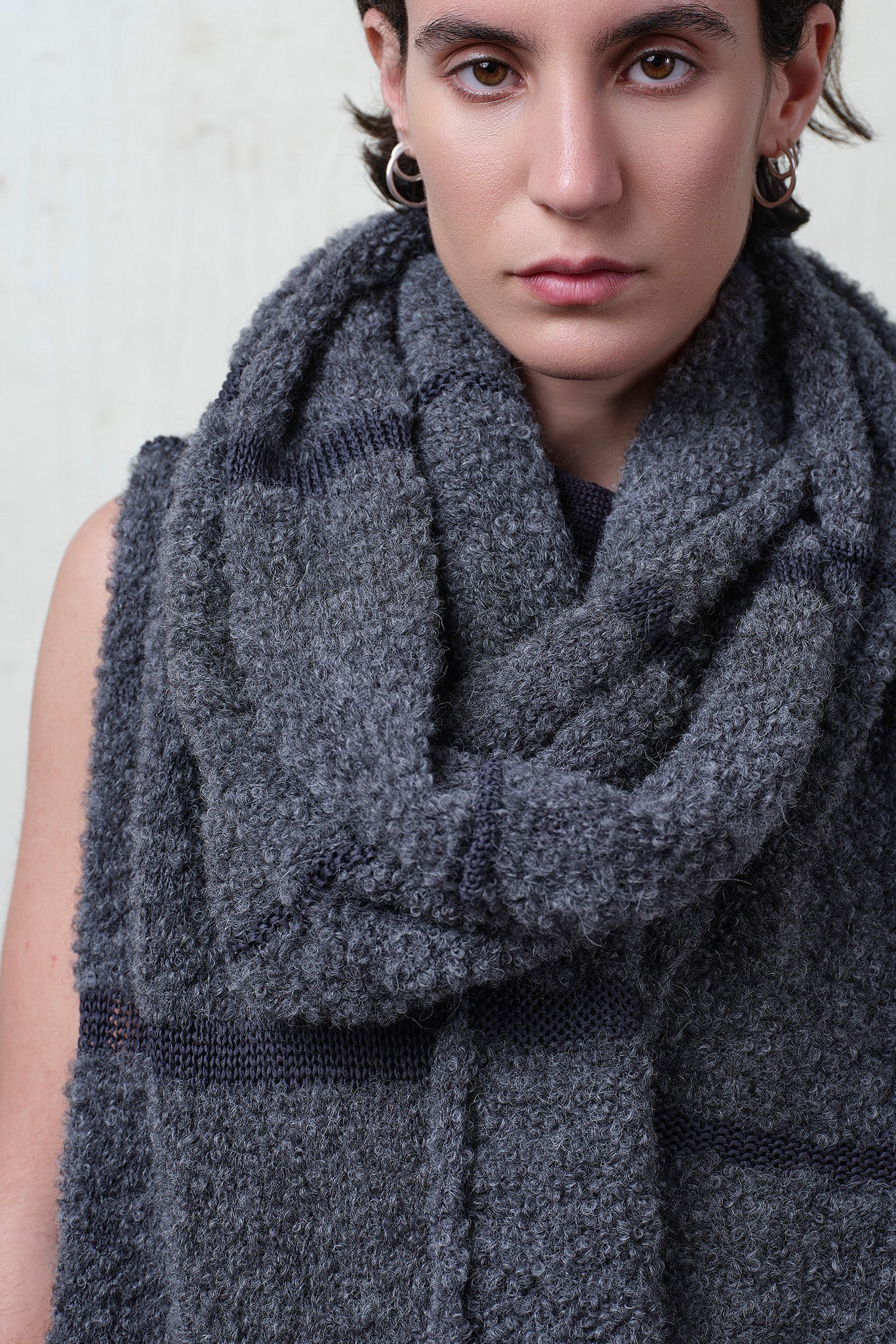 Close up fabric view of knitted alpaca wrap in storm grey with contrasting slate cotton stripes.