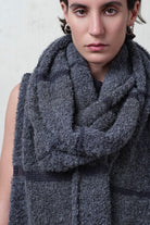 Close up fabric view of knitted alpaca wrap in storm grey with contrasting slate cotton stripes.