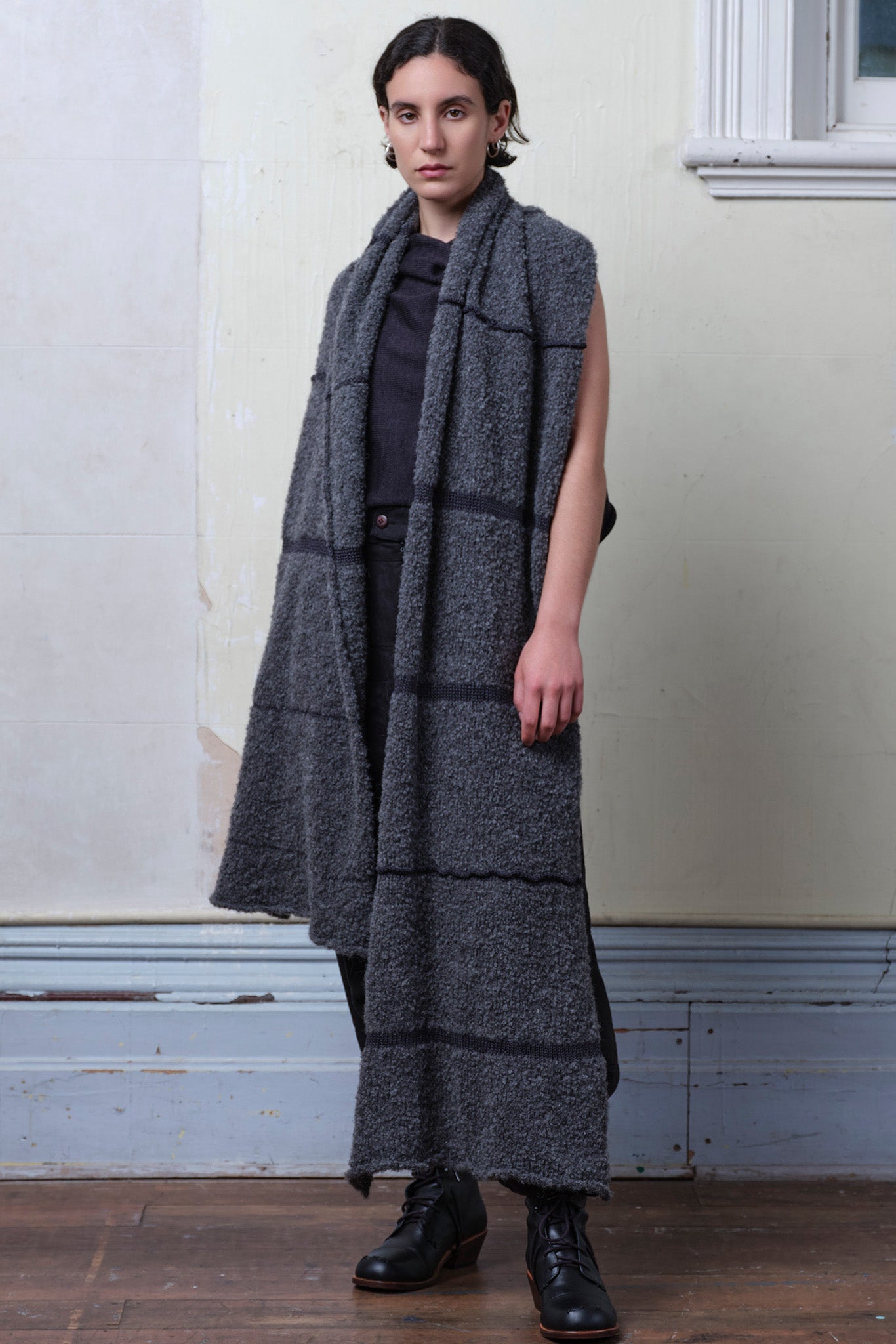 Model wears knitted alpaca wrap in storm grey with contrasting slate cotton stripes.