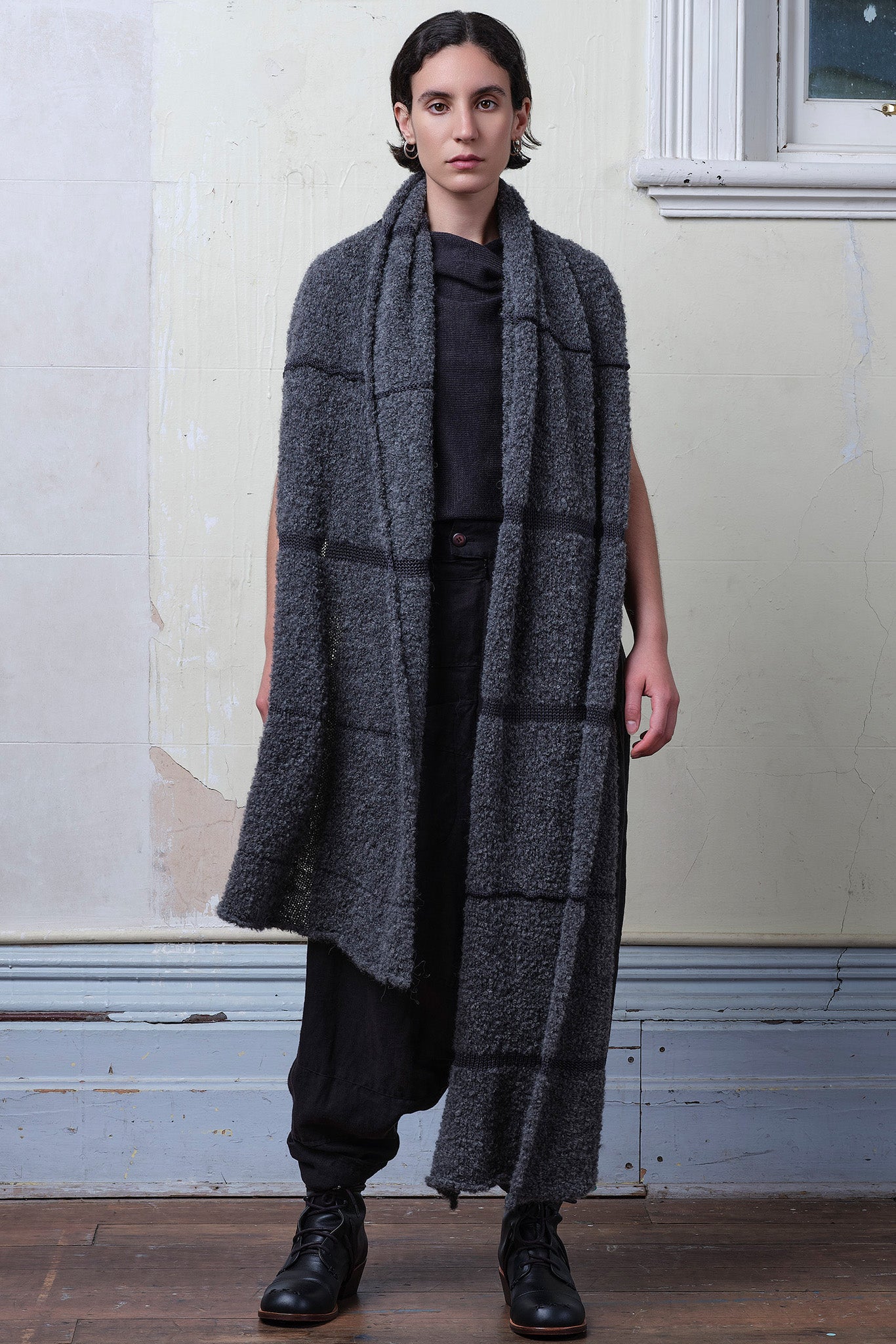 Model wears knitted alpaca wrap in storm grey with contrasting slate cotton stripes.