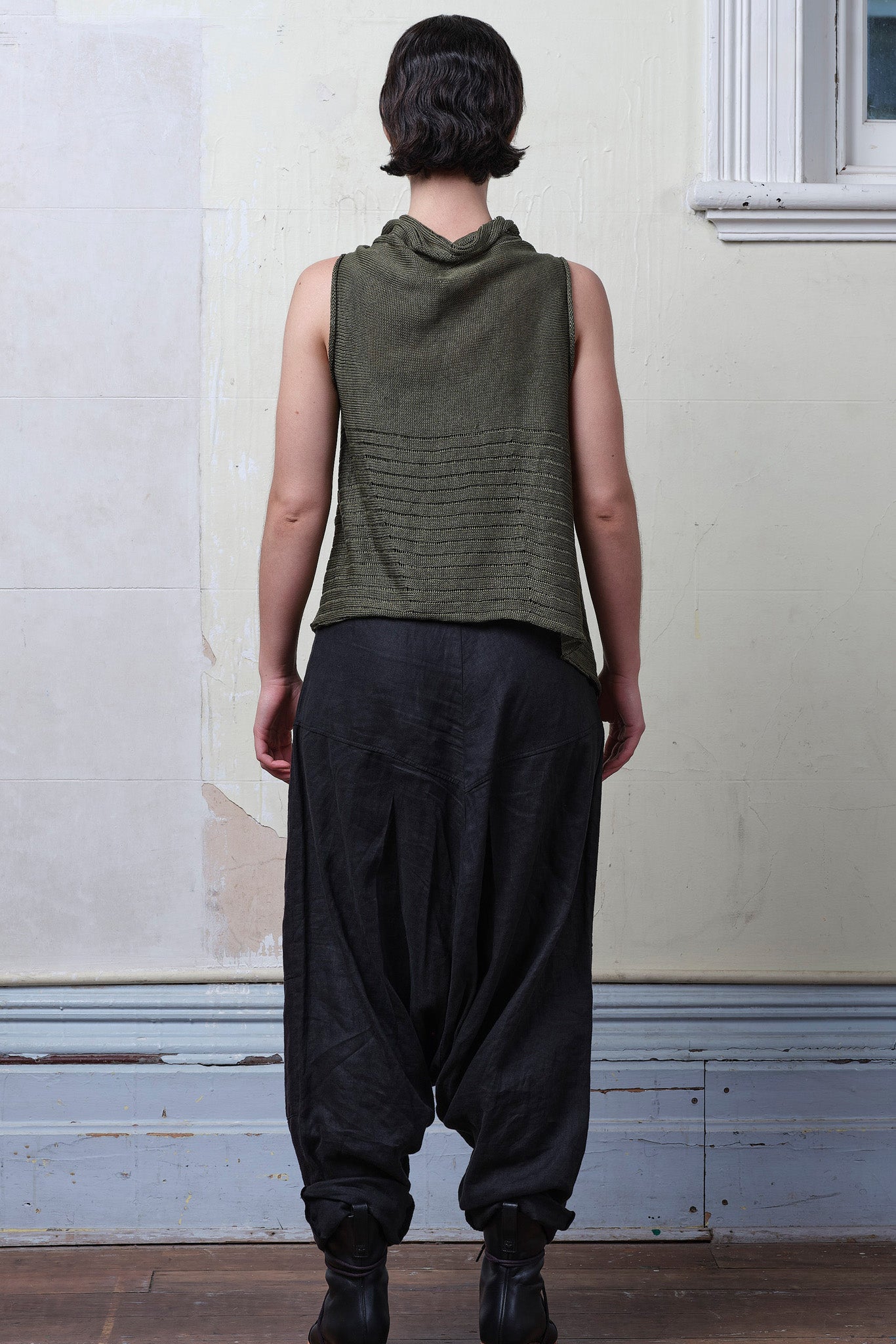 Model wears army linen/cotton laddered vest. Designed and knitted in Melbourne by Wendy Voon knits.