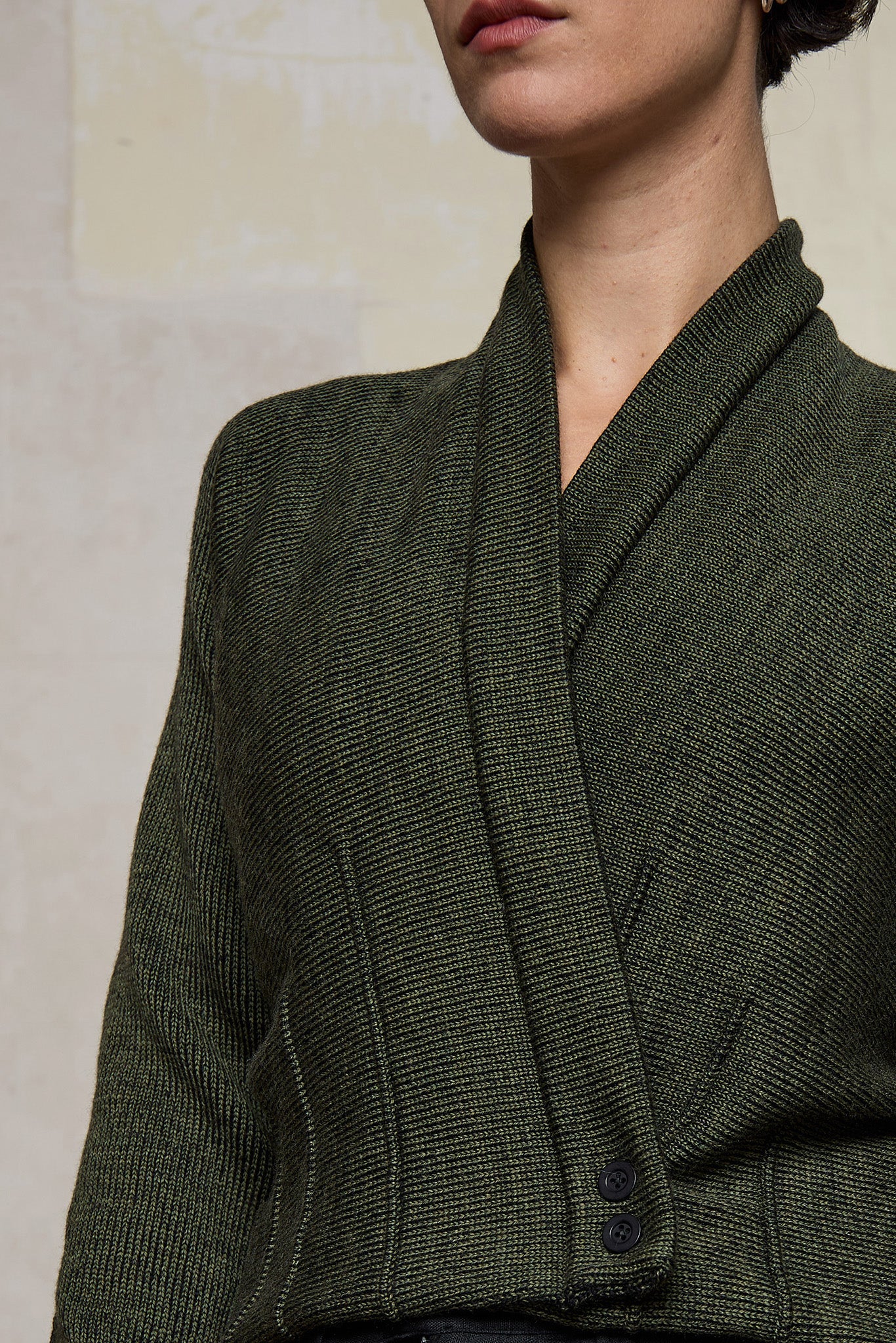 Close up fabric view of welted wool cardigan buttoned up in army backed with black colourway. Designed and made in Melbourne by Wendy Voon knits.
