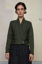 Model wears welted wool cardigan buttoned up in army backed with black colourway. Designed and made in Melbourne by Wendy Voon knits.
