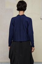 Back view of model wearing welted wool cardigan in blue backed with black colourway. Designed and made in Melbourne by Wendy Voon knits.