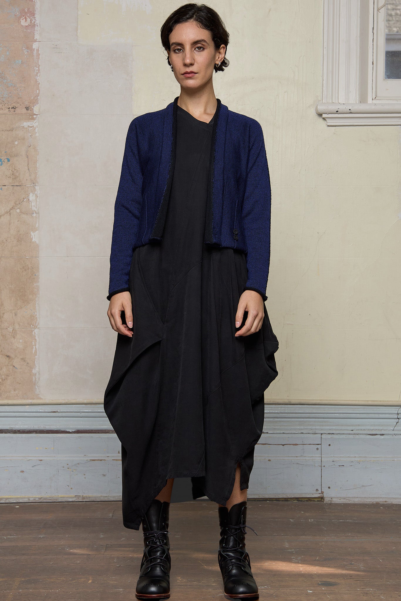 Model wears welted wool cardigan  in blue backed with black colourway. Designed and made in Melbourne by Wendy Voon knits.