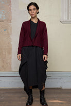 Model wears welted wool cardigan buttoned up in burgundy backed with black colourway. Designed and made in Melbourne by Wendy Voon knits.