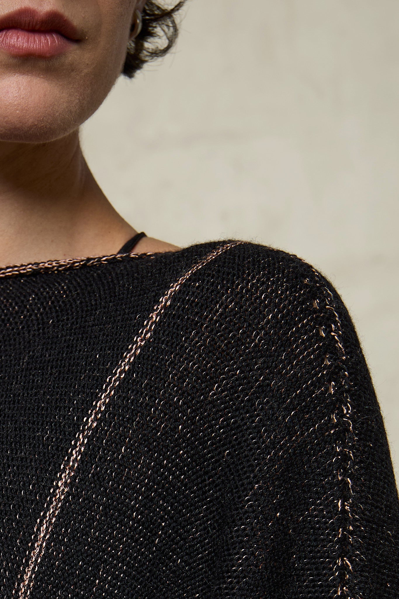 Front view Fabric close up of metallic dolmain jumper with pink gold shimmering through black, designed and knitted in Melbourne by Wendy Voon knits