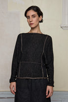 Front view focus on metallic dolmain jumper with pink gold shimmering through black, designed and knitted in Melbourne by Wendy Voon knits