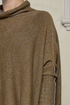 Close up fabric view of model wearing a wool boxed shaped jumper in mustard backed with grey merino wool, designed and made in Melbourne by Wendy Voon knits.