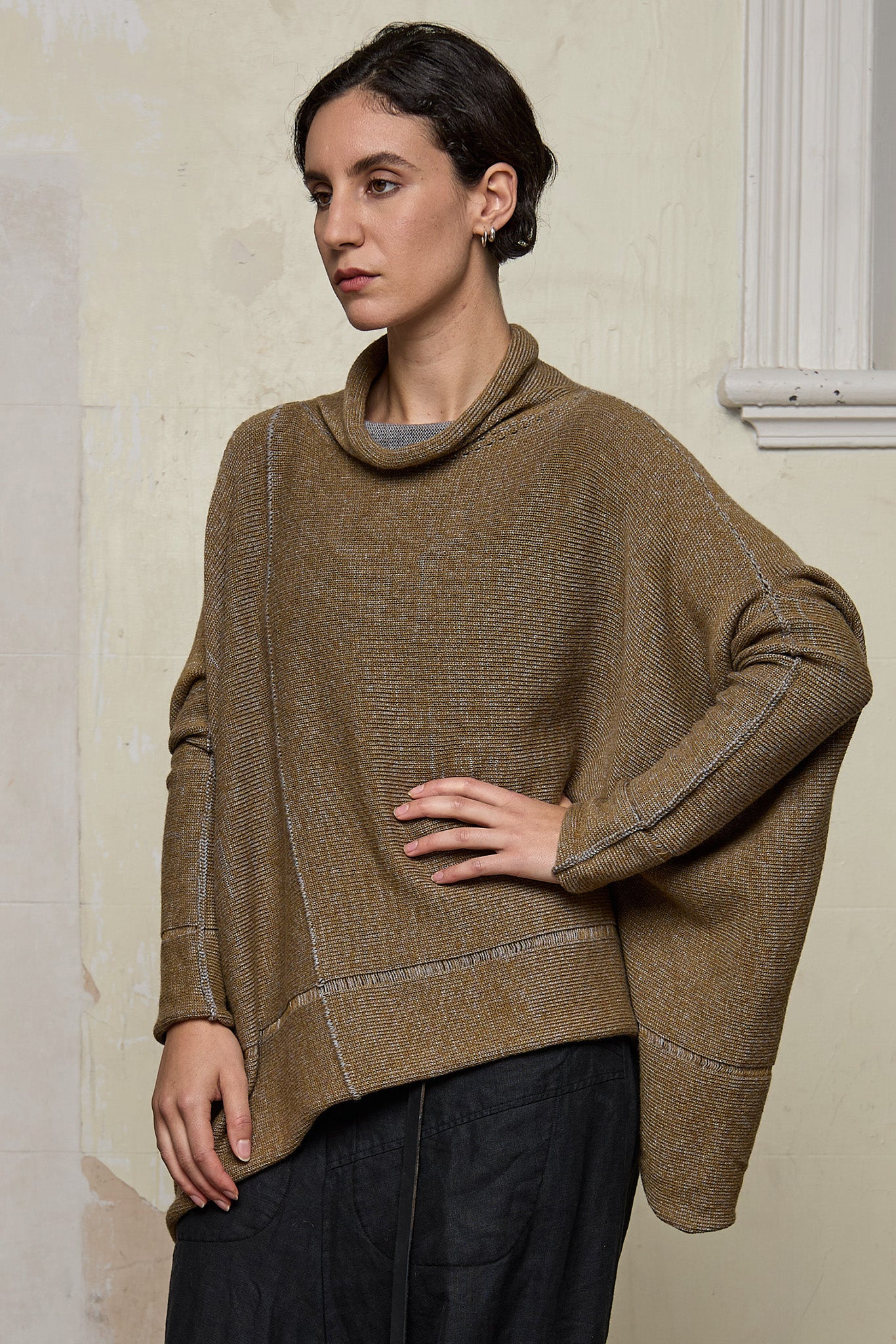 Front view of model wearing a wool boxed shaped jumper in mustard backed with grey merino wool, designed and made in Melbourne by Wendy Voon knits.