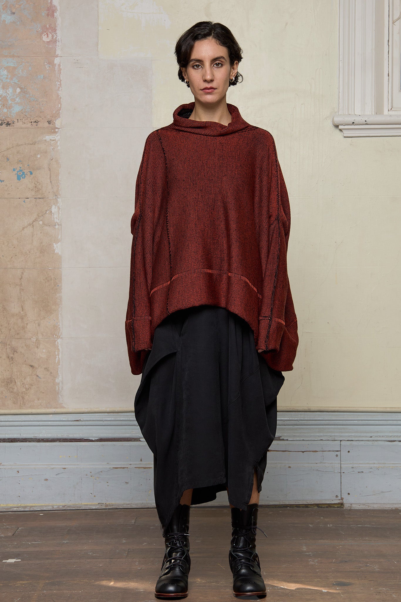 Front view of box shaped jumper designed by Wendy Voon, in a vermillion with black backed fabric. Made from superfine merino wool.