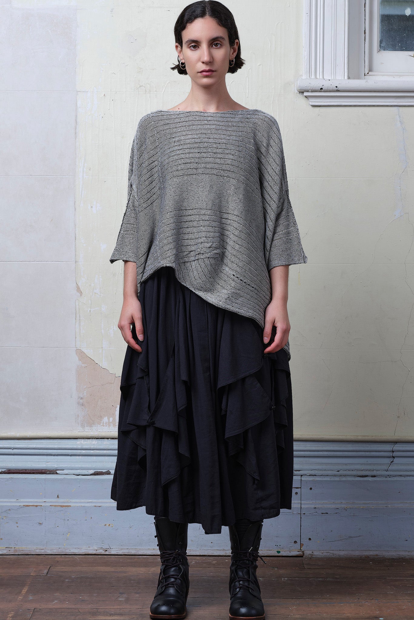 Model wears linen/cotton tulip top in silver grey backed with black.