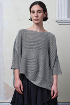 Model wears linen/cotton tulip top in silver grey backed with black.