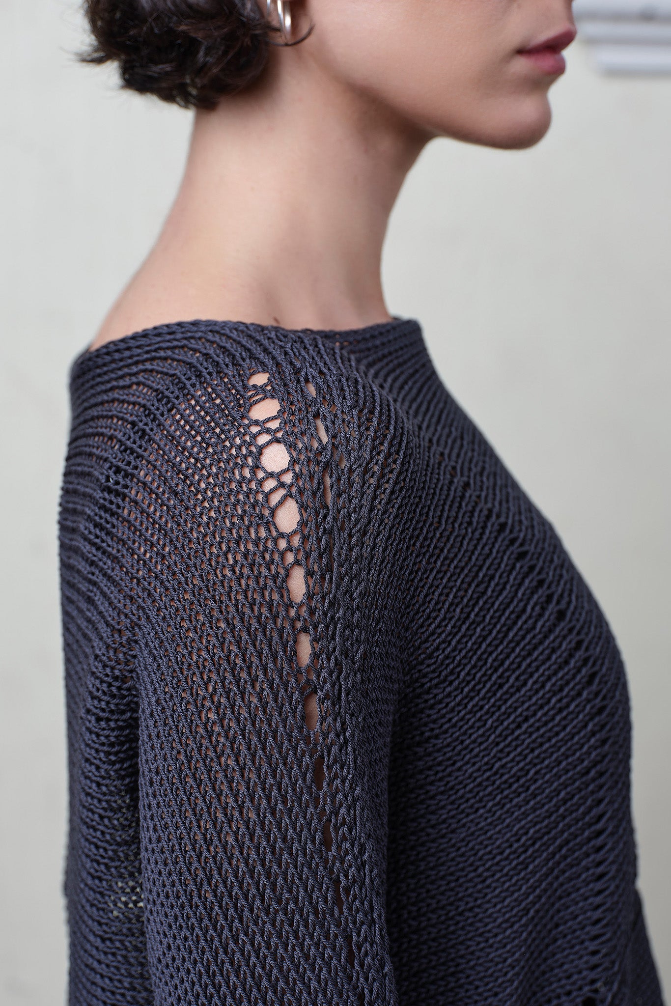 Close up fabric view of Cotton Batwing  in slate colourway, featuring large stitch details,  designed by Wendy Voon knits.