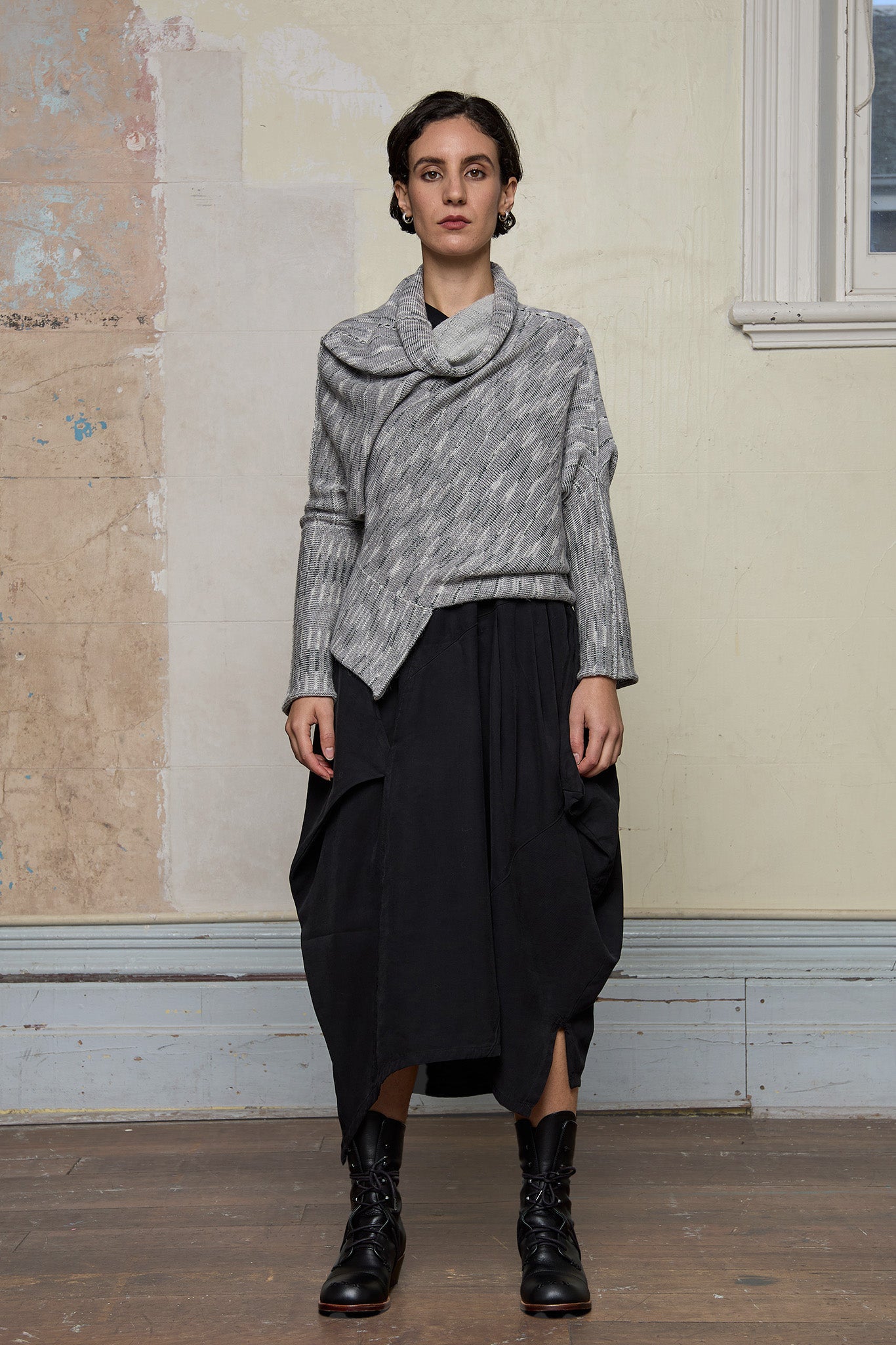 Model wears a alpaca/wool/cotton variegated  bias cut jumper in a winter melange colourway, a designed by Wendy Voon and made in Melbourne.