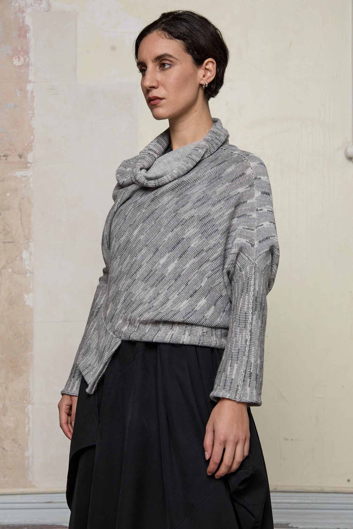 Side profile view of a alpaca/wool/cotton variegated  bias cut jumper in a winter melange colourway, a designed by Wendy Voon and made in Melbourne.