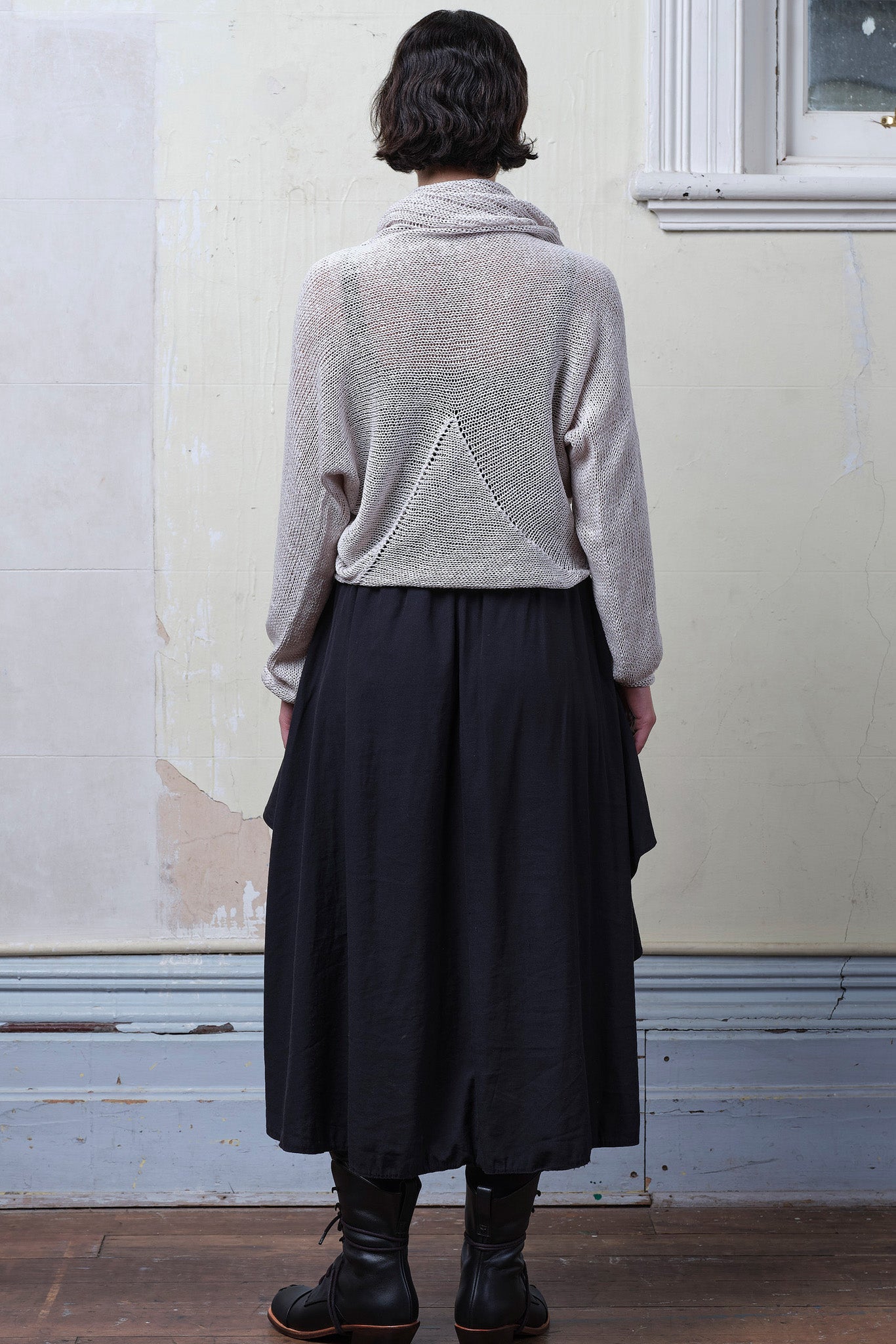 Back view of model wearing pearl coloured knitted back scoop jumper in a cotton/linen blend. Designed and knitted in Melbourne by Wendy Voon knits.