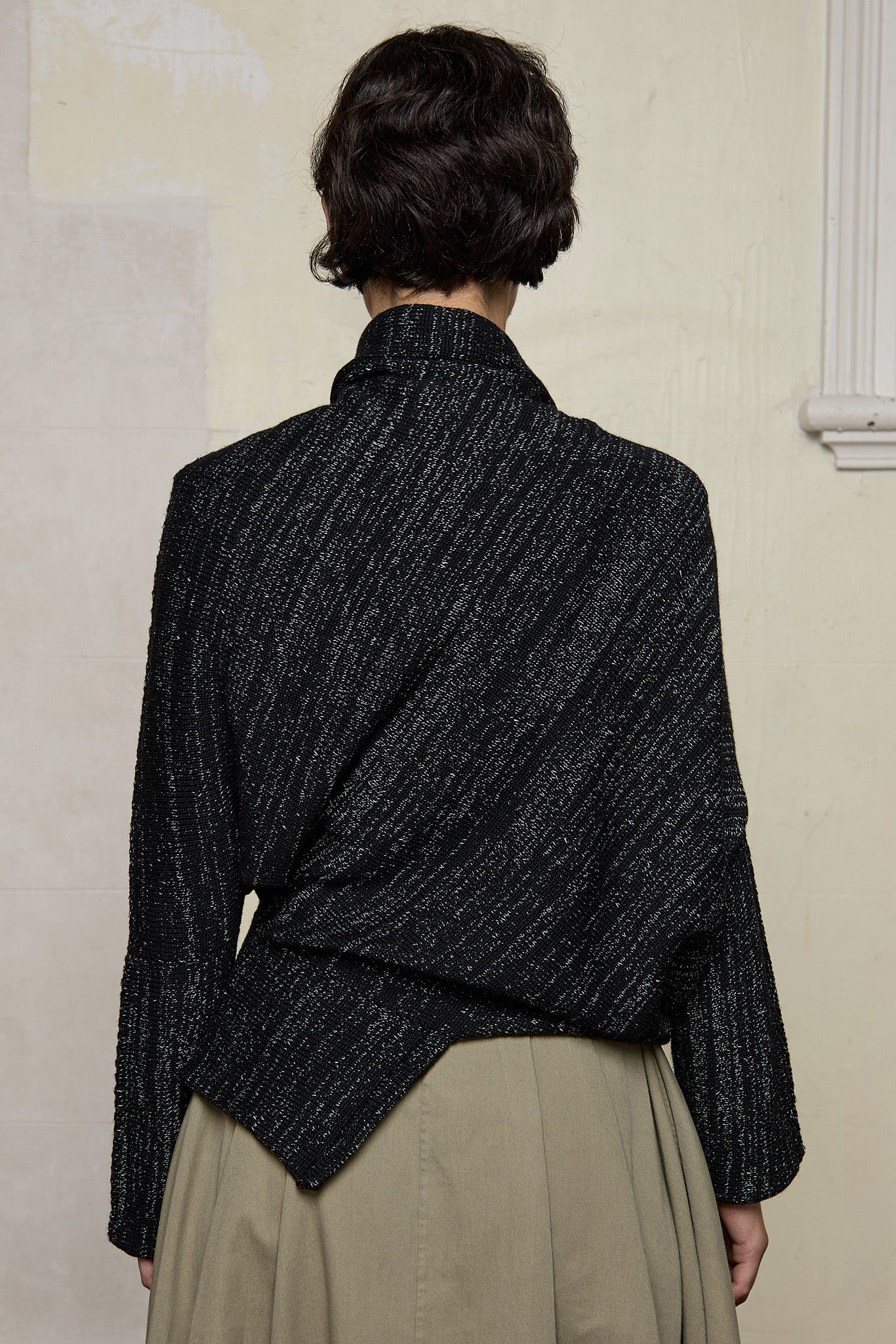 Back view of Bias jumper, a design by Wendy Voon knits in a black flecked with white merino wool and linen/cotton blend fabric.
