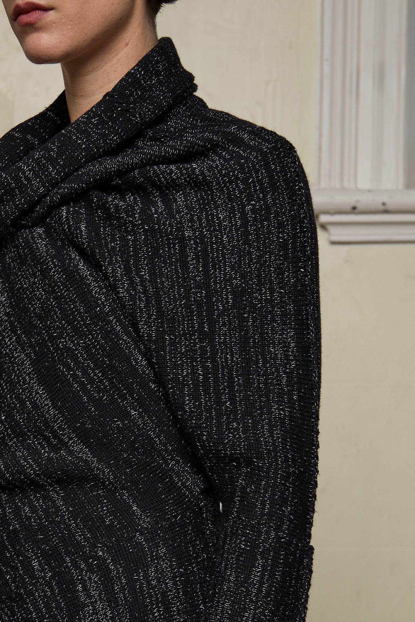 Close up fabric view of Bias jumper, a design by Wendy Voon knits in a black flecked with white merino wool and linen/cotton blend fabric.