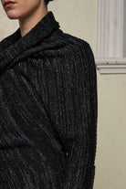 Close up fabric view of Bias jumper, a design by Wendy Voon knits in a black flecked with white merino wool and linen/cotton blend fabric.