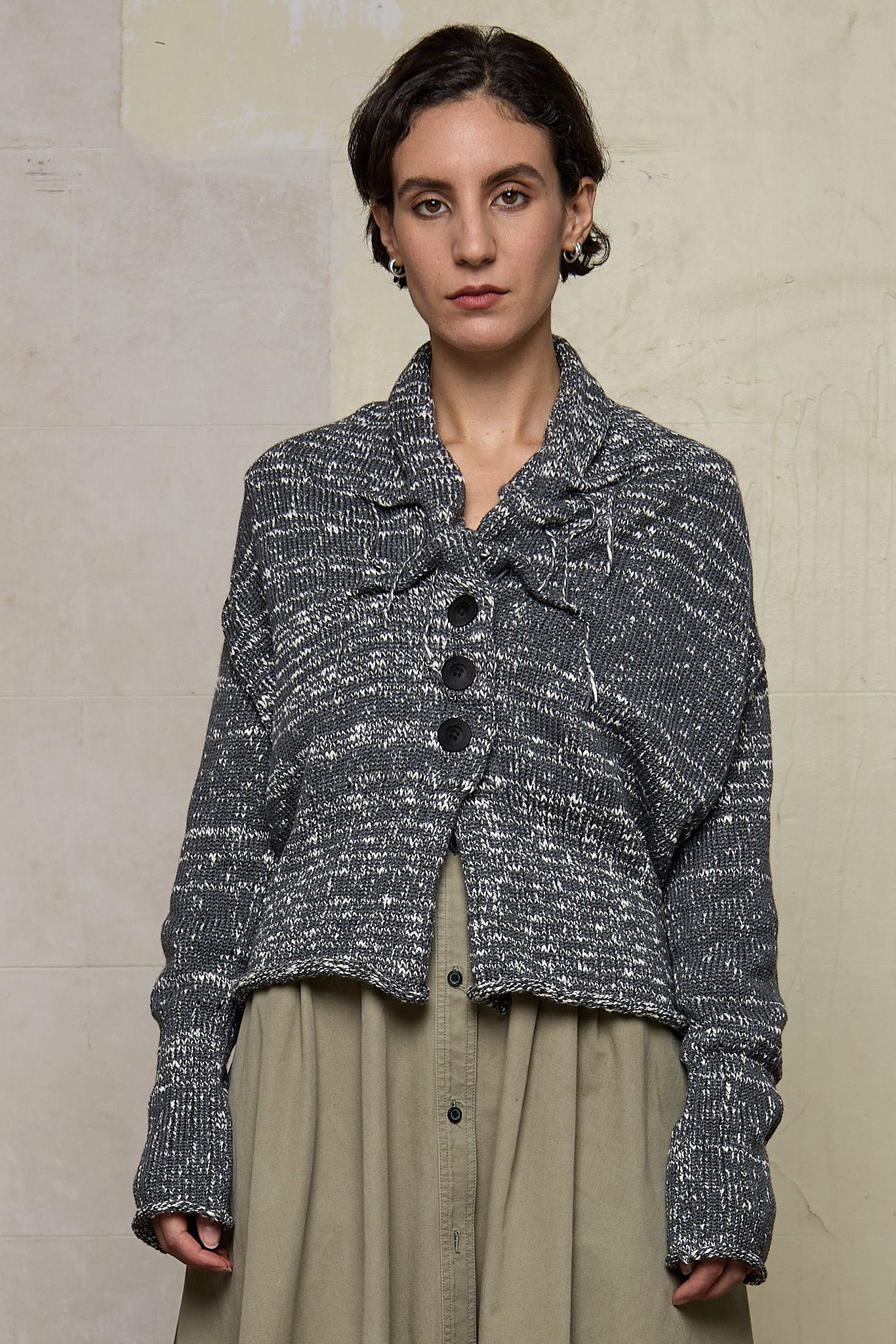 Front view of grey flecked chunky knit cardigan, with ruched detail. Designed and made by Wendy Voon knits