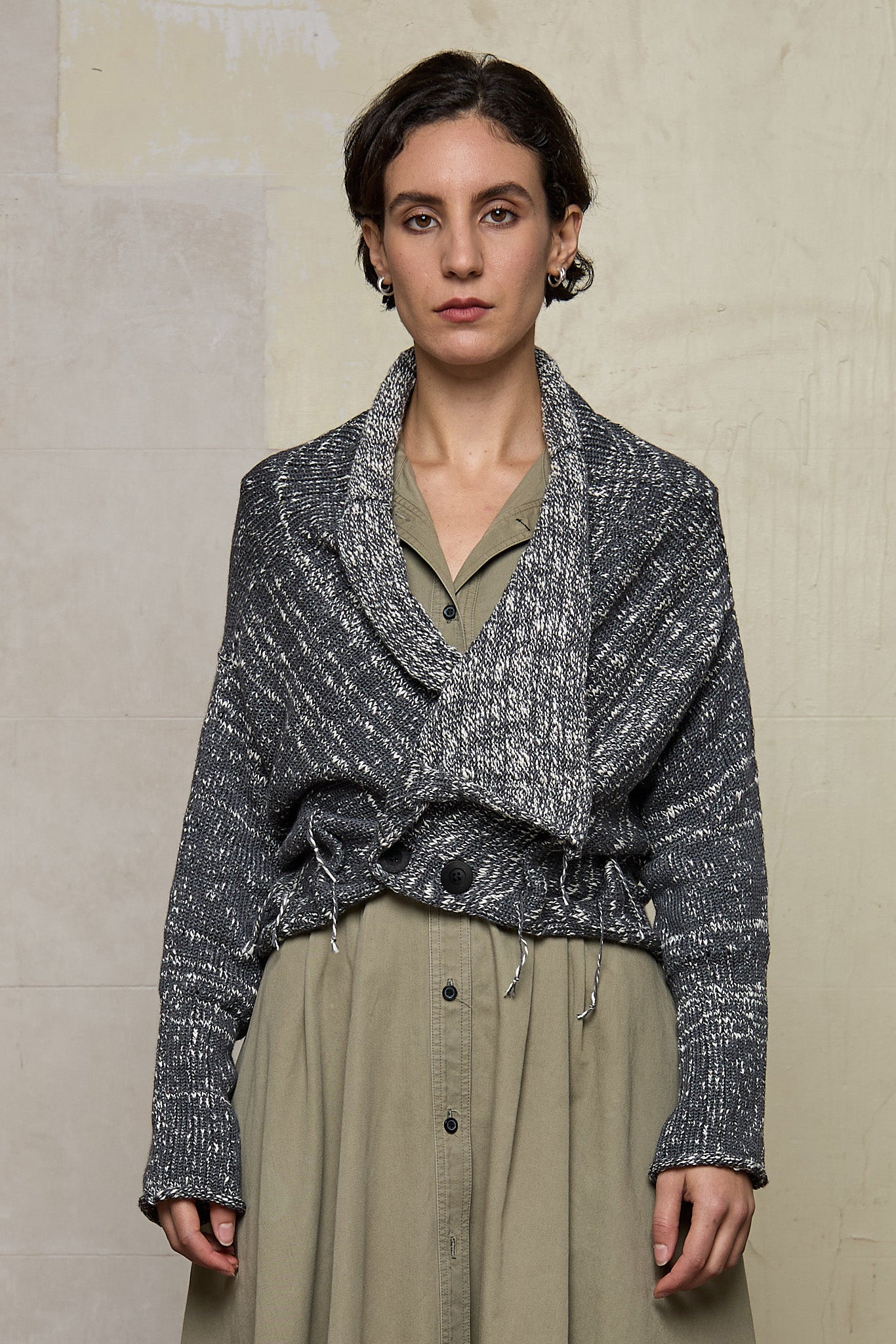 Front view of grey flecked chunky knit cardigan, with ruched detail, worn upside down. Designed and made by Wendy Voon knits