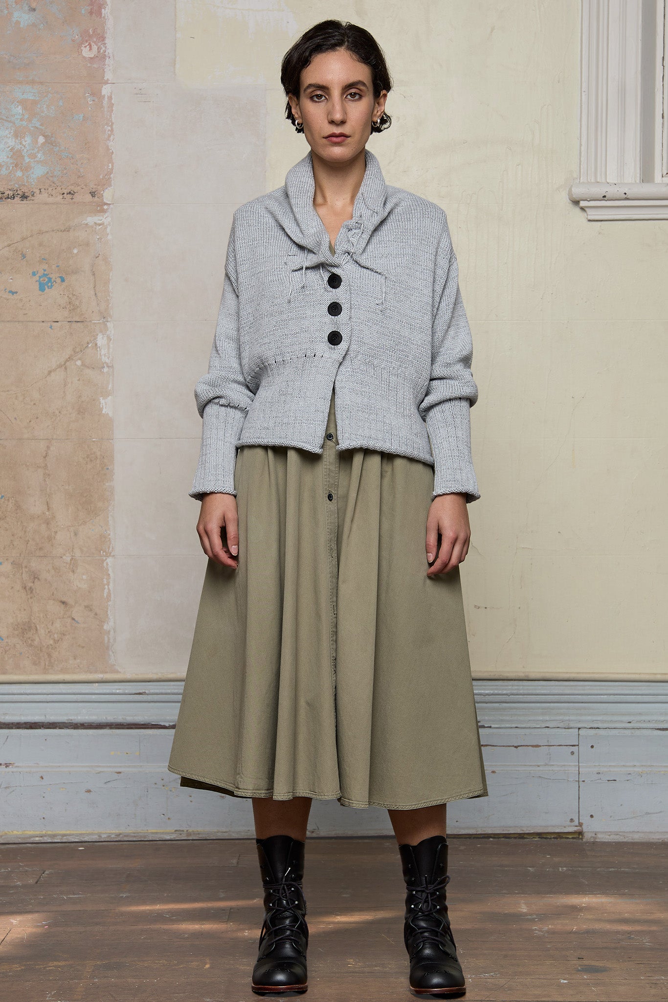 Front view of off white superfine merino wool ruched cardi, worn buttoned up.  Designed and made by Wendy Voon knits.