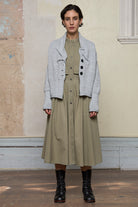 Front view of off white superfine merino wool ruched cardi, worn unbuttoned.  Designed and made by Wendy Voon knits.