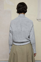 Back view of off white superfine merino wool ruched cardi, worn upside down.  Designed and made by Wendy Voon knits.