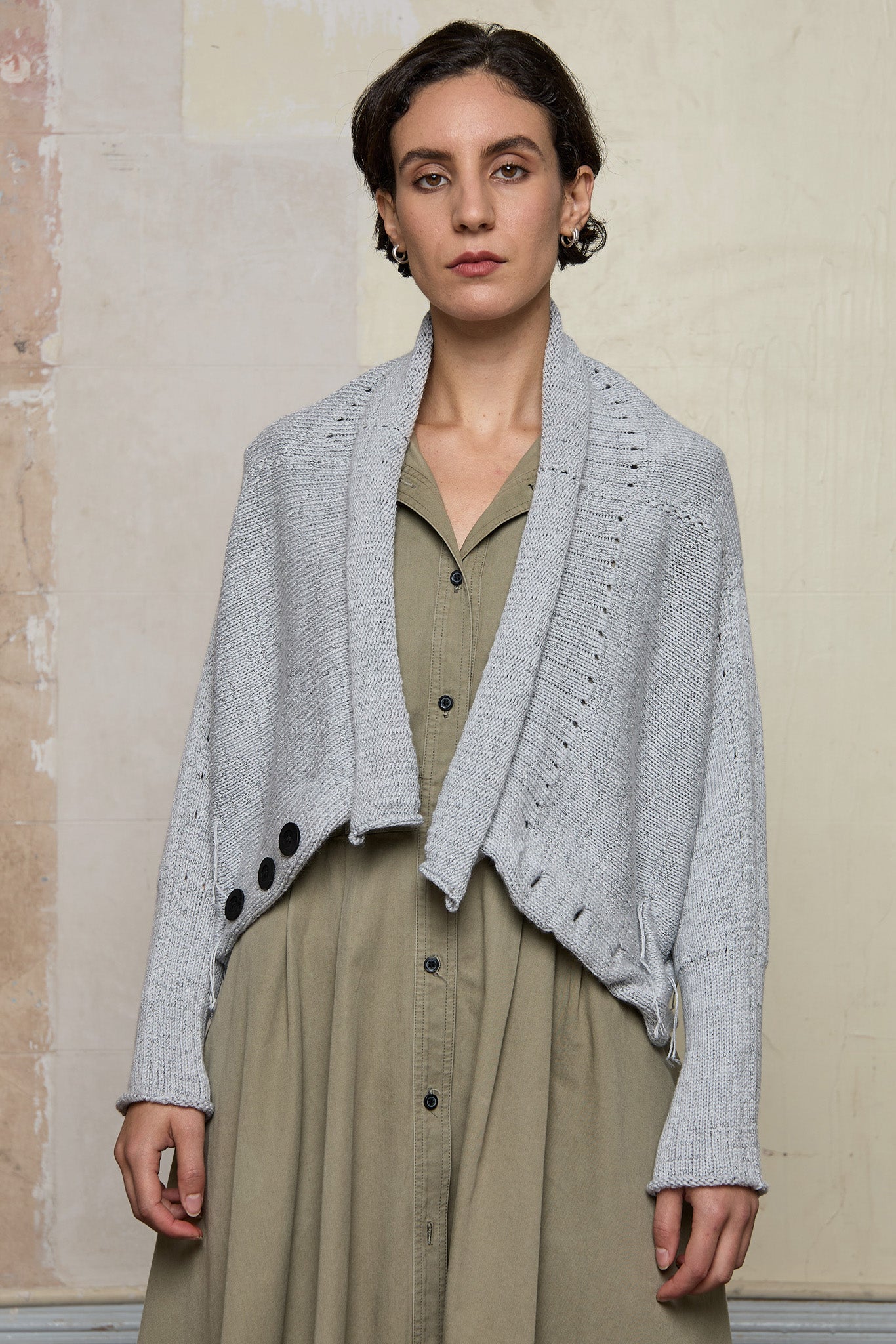 Front view of off white superfine merino wool ruched cardi, worn upside down and unbuttoned.  Designed and made by Wendy Voon knits.