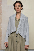 Front view of off white superfine merino wool ruched cardi, worn upside down and unbuttoned.  Designed and made by Wendy Voon knits.