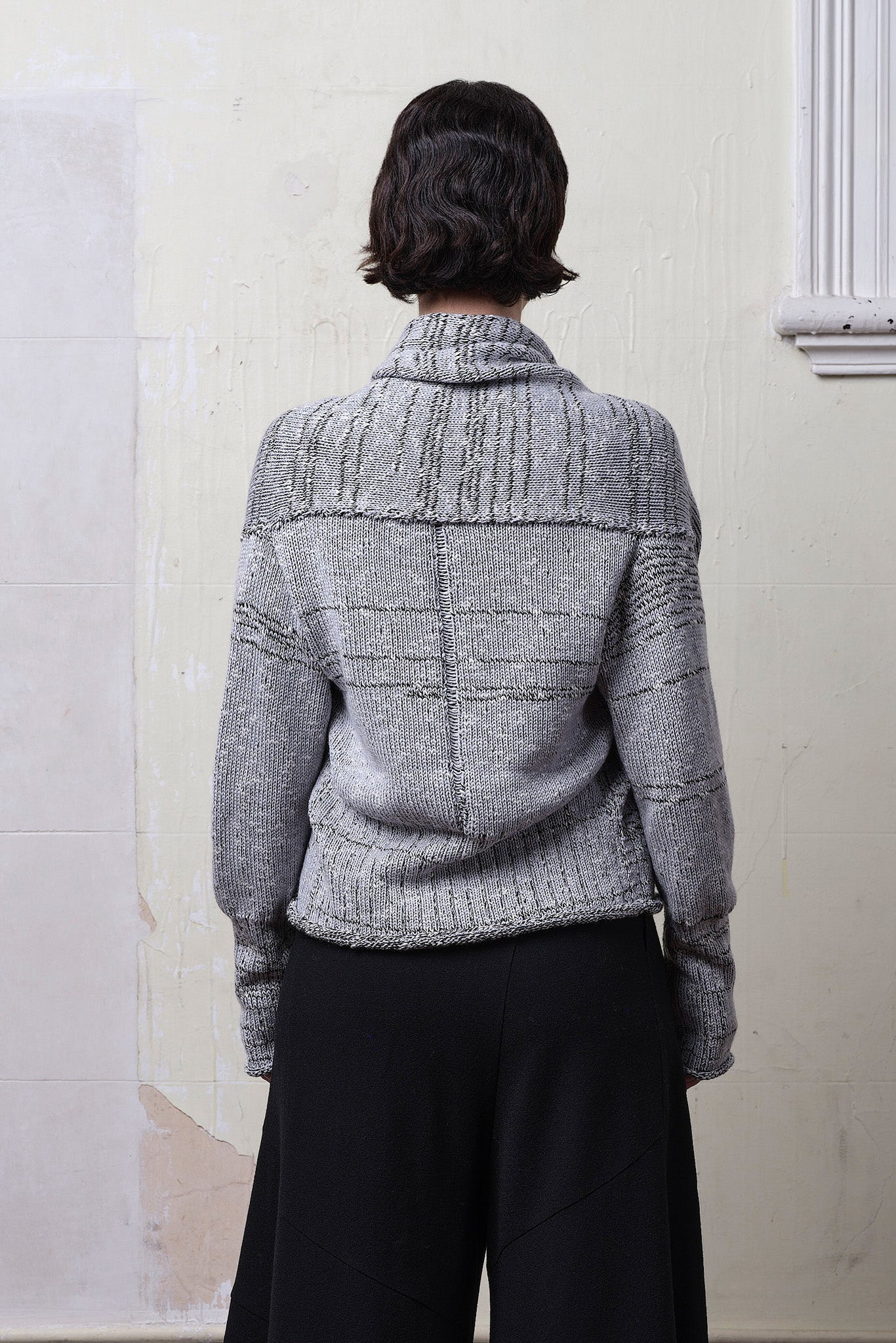 Model wears cotton and superfine merino ruched cardigan in white, grey and black melange colourway. Designed and knitted in Melbourne by Wendy Voon Knits