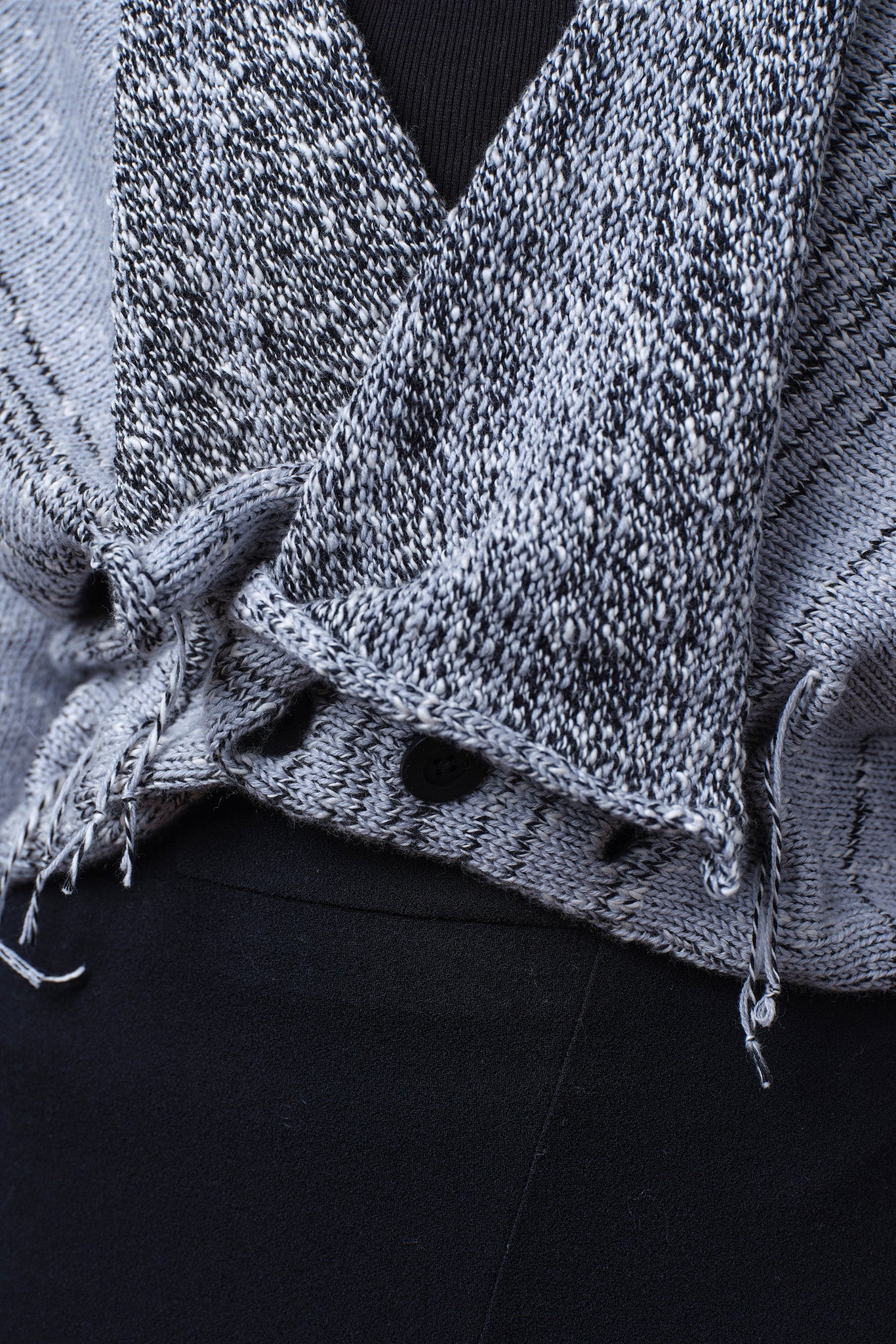 Close up fabric detail of cotton and superfine merino ruched cardigan in white, grey and black melange colourway. Designed and knitted in Melbourne by Wendy Voon Knits