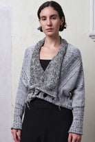 Model wears cotton and superfine merino ruched cardigan upside down in white, grey and black melange colourway.
