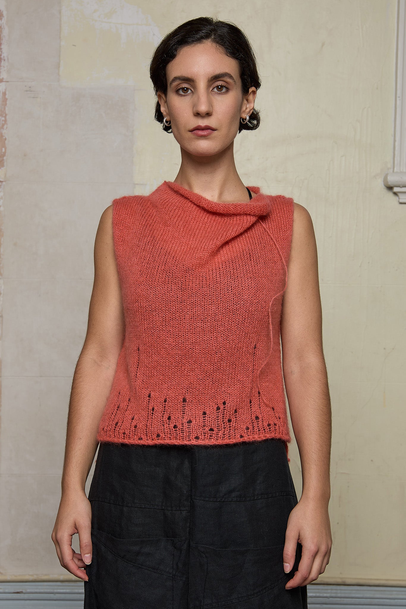 Front view of model wearing super lush knitted vest in carrot colourway, designed and knitted in Melbourne by Wendy Voon knits